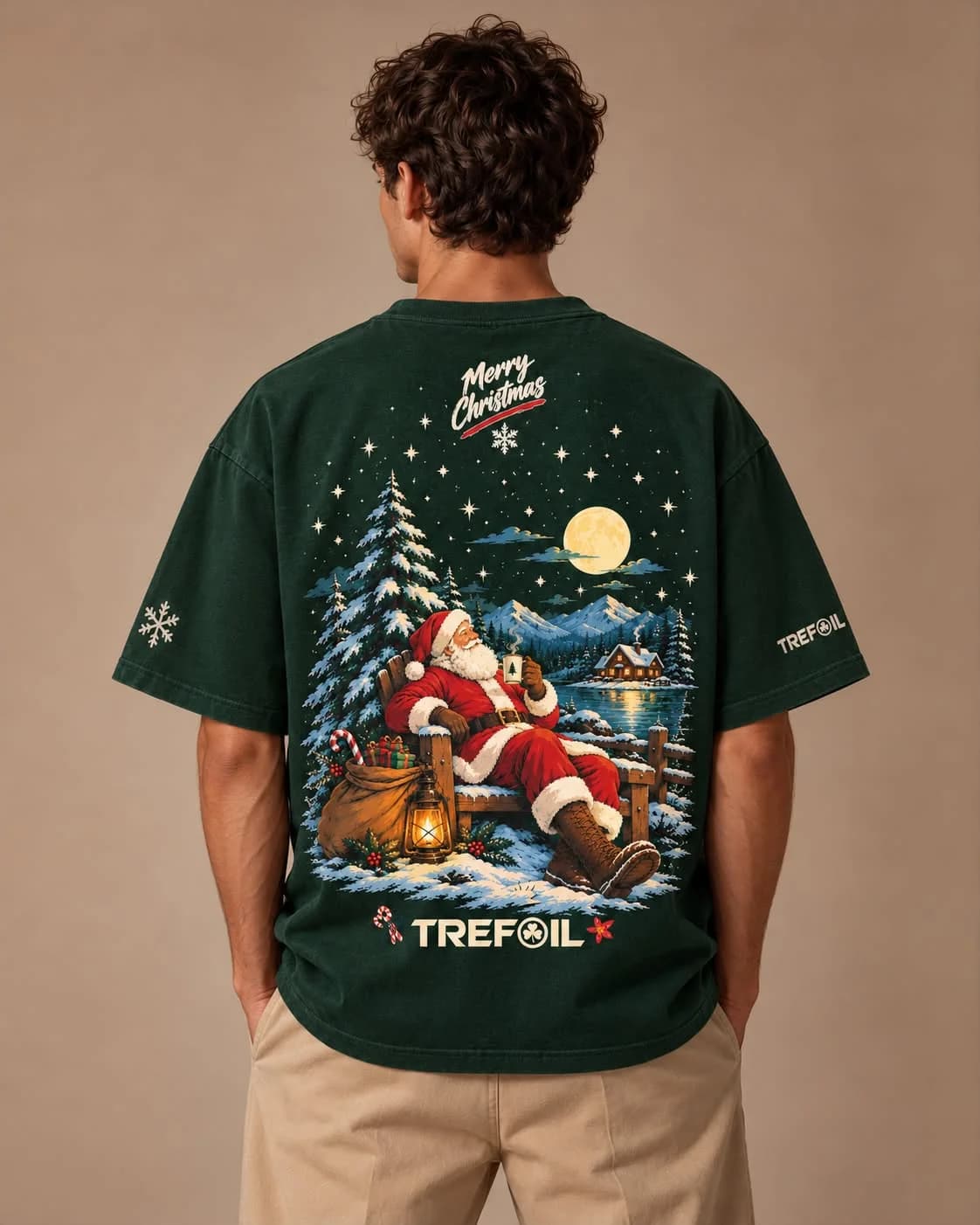 Fireside Santa Tee in forest green, back print of Santa resting by a moonlit lake